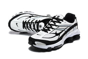 Pair of white and black Nike Shox R4 sneakers viewed from above and at an angle.