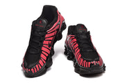 Front and top views of black and pink lace-up sneakers.