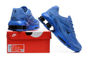Blue Nike Shox Ride 2 sneakers shown beside a shoebox; the box label displays a sample size.