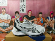 Side view of a white basketball sneaker with black accents and ASICS branding