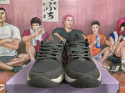 Front view of gray and black Nike basketball sneakers showing the laces, perforated toe areas, tongue branding, and textured outsoles.