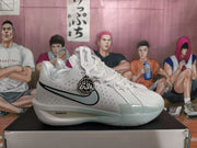 Side view of a white and grey Nike LeBron basketball shoe with a pale blue-grey side logo and black trim.