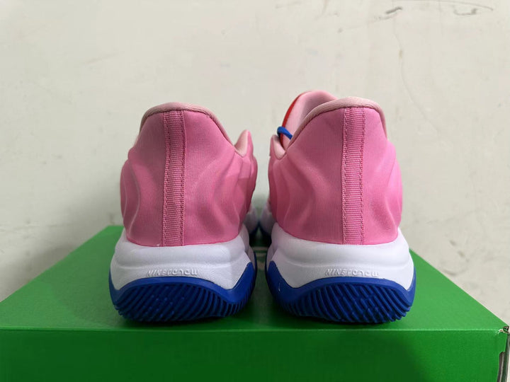 Rear view of pink Nike basketball shoes with white midsoles and blue outsoles.