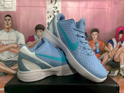 Pair of blue and teal Nike Kobe basketball shoes shown at an angle