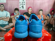 Rear view of the blue sneakers showing Nike branding on the heel and padded ankle collars.