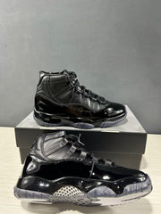 Side and outsole view of two black high-top sneakers showing glossy panels and translucent gray traction sections.