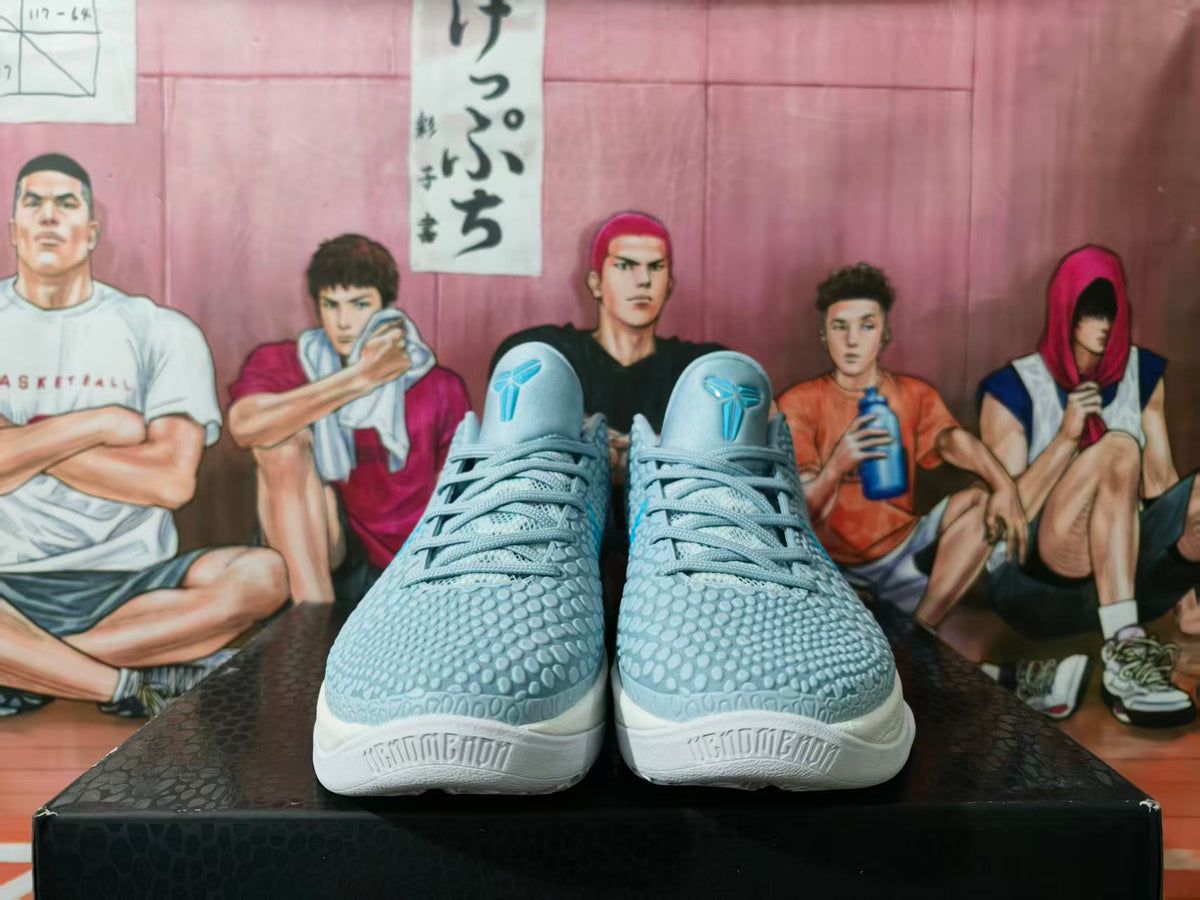 Front view of gray and blue basketball sneakers with textured uppers, blue tongue logos, gray laces, and white midsoles.