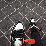 Close-up top view of the black laces, white toe box, and contrasting black trim.