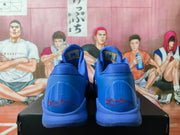 Rear view of the blue basketball sneakers showing heel details, red signatures, and visible number markings.