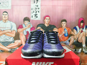 Front view of black and purple Nike Air Max Plus sneakers