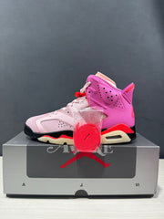 Side profile showing the perforated pink collar panel, layered upper, and visible heel air unit.