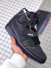 Angled front-side view showing the black upper, laces, Jordan branding, and attached hangtags.