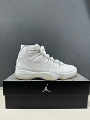 Side profile of a white high-top sneaker displayed on a black shoebox.
