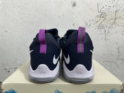Rear view of navy and white Nike PG 1 basketball shoes with purple heel pull tabs