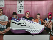 Side view of a white and purple Nike basketball shoe with visible Air Zoom marking