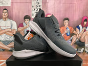 Angled side view showing the textured upper, perforated side panel, padded collar and layered sole.