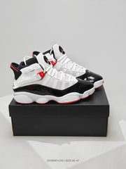 Pair of white, black, and red high-top sneakers displayed on a black shoebox.