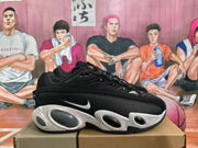 Side view of a black Nike sneaker with a white swoosh, textured side panel, and rounded visible cushioning elements.