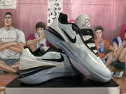 Pair of light blue-gray Nike basketball sneakers shown from the side on a shoe box.