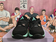 Front view of black basketball sneakers with mint-green outsole accents, black laces, and basketball-style tongue logos.