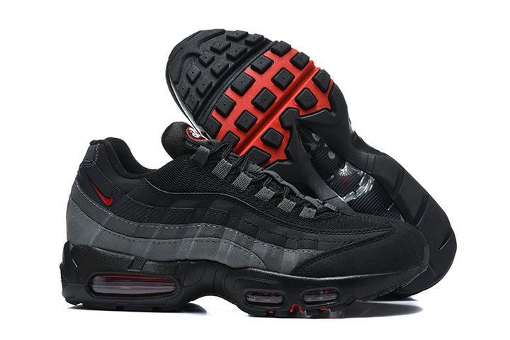 Nike Air Max 95 sneakers showing the black and red patterned outsole and layered black and grey side panels.