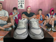 Front view of gray and pink Nike sneakers with white laces and textured toe areas.