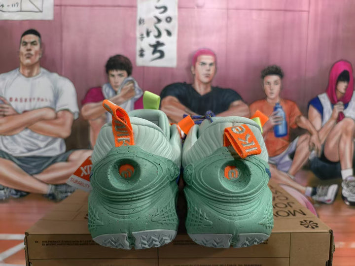 Rear view of blue and green Nike sneakers with orange pull tabs and heel details.