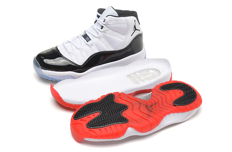 White and black high-top Jordan sneakers shown with one shoe elevated and the translucent outsole visible.