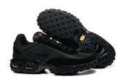 Black Nike Air Max Waffle SP sneakers shown with a view of the lugged outsoles.