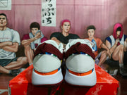 Rear view of the white and burgundy Nike Ja 1 basketball shoes showing the heel panels and burgundy outsole edges.