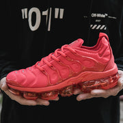 Side view of a red Nike sneaker with a translucent segmented sole.
