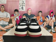 Front view of black and white low-top Nike sneakers with lace-up closure.