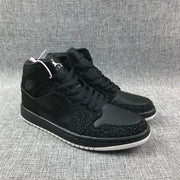 Pair of black Air Jordan 1 Mid-style sneakers viewed from the front three-quarter angle.