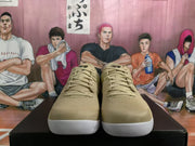 Front view of beige lace-up basketball shoes with black tongue details