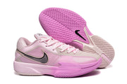Pink Nike G.T Cut Cross EP basketball sneakers with a black swoosh and pink patterned outsole.