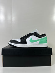 Side profile of the white, green, and black low-top sneaker on a shoebox.