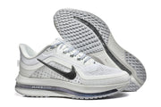 Nike Pegasus Premium shoes shown from the side and underside, highlighting the tread.