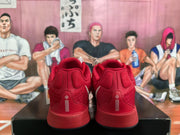 Rear view of red Nike basketball sneakers on a black shoebox, showing padded collars and heel detailing.