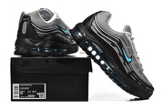 Side view of grey and black sneakers displayed on a box labeled Nike Air Max 97 OG