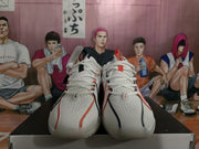 Front view of white Nike basketball sneakers with red and black accents displayed on a box.