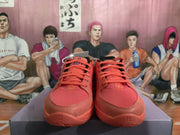 Front view of the coral pink sneakers showing matching laces, textured toe boxes, and 12-themed markings on the outsole.