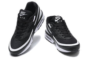 Front and top views of black and white Nike Air Max sneakers with lace-up fastening.