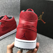 Close rear view showing the red collar, heel logo, white midsole, and gray outsole.