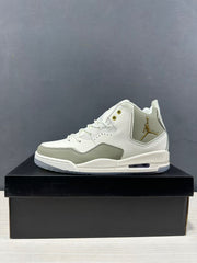Side view of one off-white and tan mid-top sneaker with gold-tone side branding.
