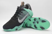 Angled view of black and mint Nike Kobe 11 All-Star shoes