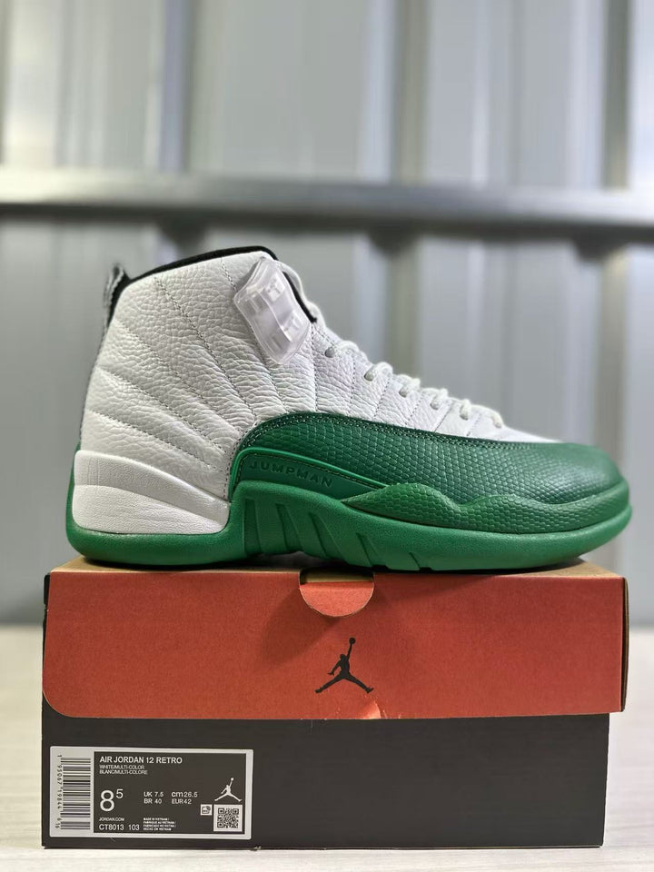 White and green Jordan Air Jordan 12 sneaker displayed on a Jordan shoebox; box label shows size EU 42, US Men 8.5, UK 7.5 and CM 26.5.