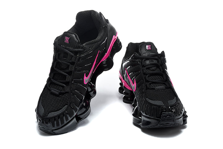 Pair of black and pink Nike Shox TL sneakers shown from front and side