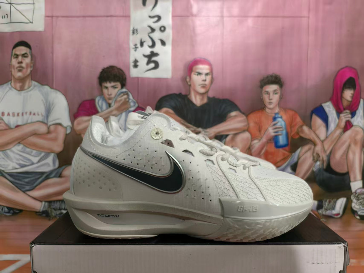 Side view of grey Nike basketball shoes with a black Swoosh and ZoomX lettering on the midsole.