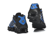 Rear and outsole views of black and blue Nike Shox sneakers