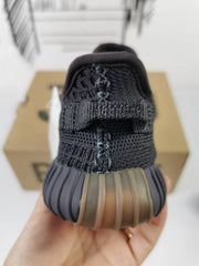 Rear view showing the heel pull tab, dark heel section, and gum-colored outsole detail.